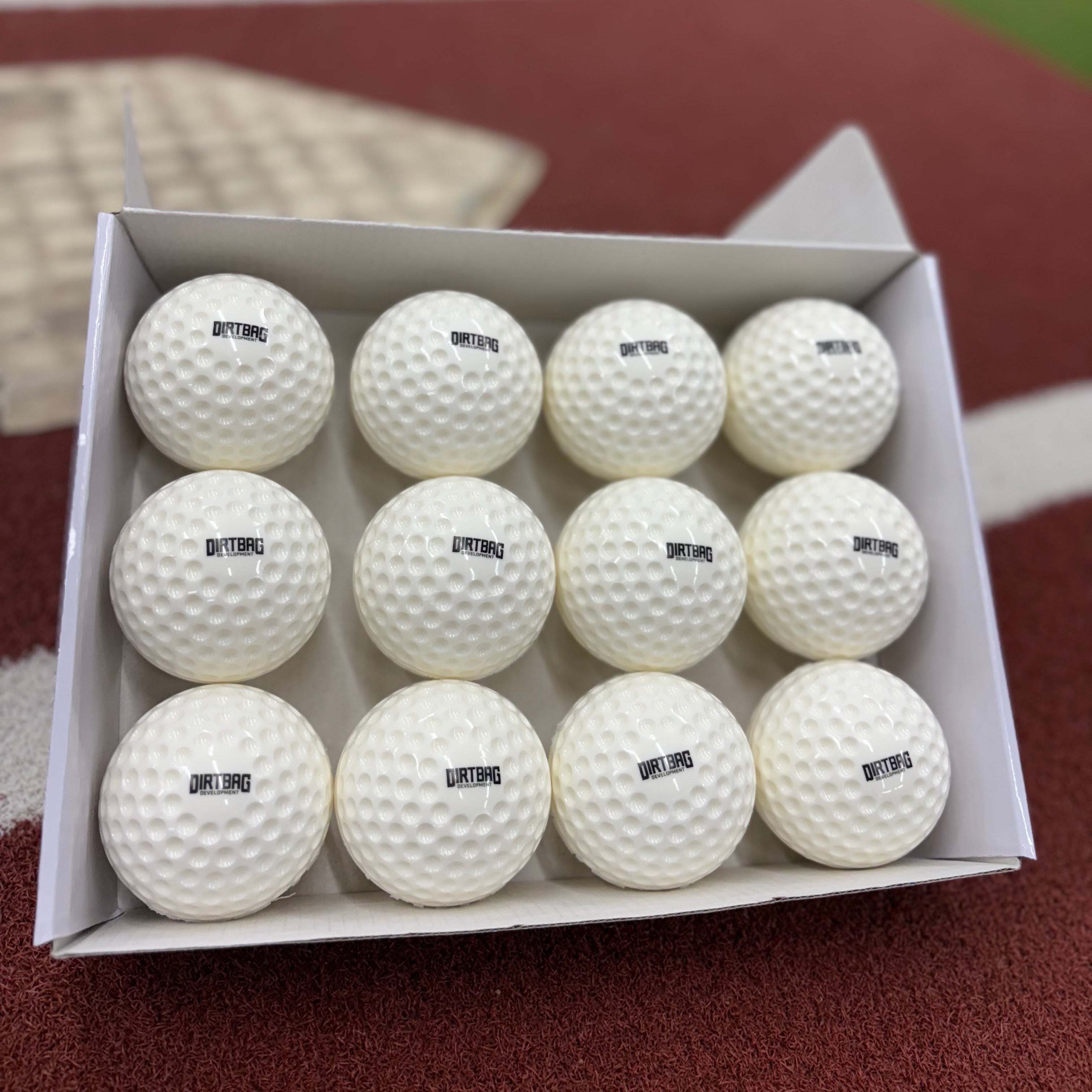 Box full of dimple baseballs